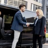 female-chauffeur-with-a-businessman-near-minivan-t-2025-03-16-03-06-55-utc female-chauffeur-with-a-businessman-near-minivan-t-2025-03-16-03-06-55-utc