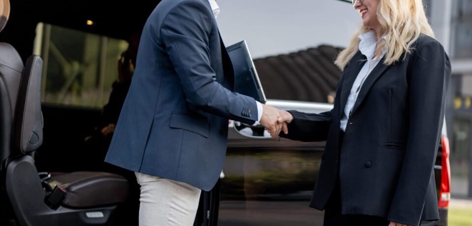 female-chauffeur-with-a-businessman-near-minivan-t-2025-03-16-03-06-55-utc female-chauffeur-with-a-businessman-near-minivan-t-2025-03-16-03-06-55-utc